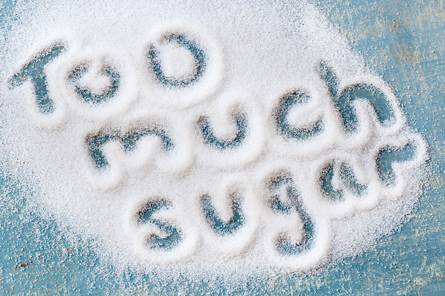 The words "too much sugar" written in sugar grains.  Overhead vi